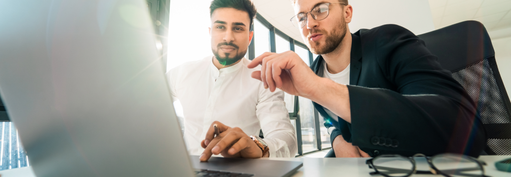 Two men in optical practice compare top practice management systems to boost efficiency and enhance patient care.